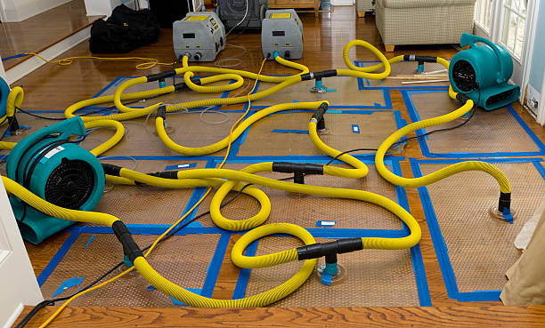 Professional Flood Damage Restoration technician working in Campbell, OH